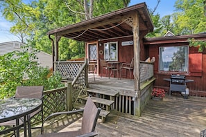 The Tree House - Deck Overlooking Lake - Relax on the spacious covered deck, perfect for outdoor dining and lounging while taking in views of Conesus Lake. This charming lakefront cabin offers a quiet retreat, just steps away from the water for endless out
