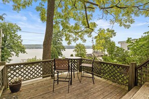 The Tree House - Deck Overlooking Lake - Take in serene lake views from this elevated deck, a peaceful spot to enjoy morning coffee or evening drinks. The private seating area provides an ideal space for relaxation, just steps away from lake access.