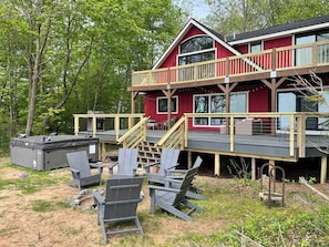 Hot tub and fire pit area near the back decks. Decks were just rebuilt and will be stained in the fall.