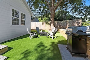 Fenced in Backyard with Fire Pit, Gas Grill, Putting Green and Cornhole. 