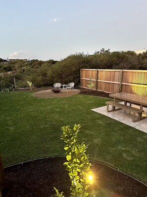 Private backyard with fire-pit, BBQ, outdoor dining table and ample lawn space