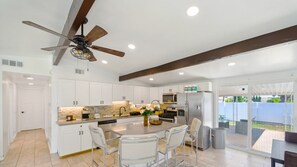 The kitchen and kitchenette feature a gas stove, coffee machine, and more.