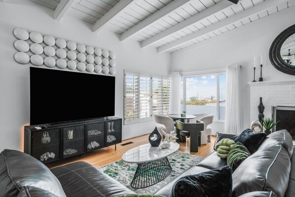 Spacious living room with plenty of seating featuring smart TV with streaming services