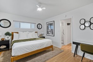 Bedroom featuring a comfy king bed, and workspace.