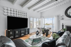 Spacious living room with plenty of seating featuring smart TV with streaming services