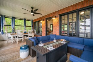 Fully screened in porch with lots of seating and large dining table