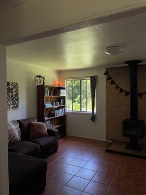 Cosy living area with bookcase full of literature on birds, nature and wildlife.