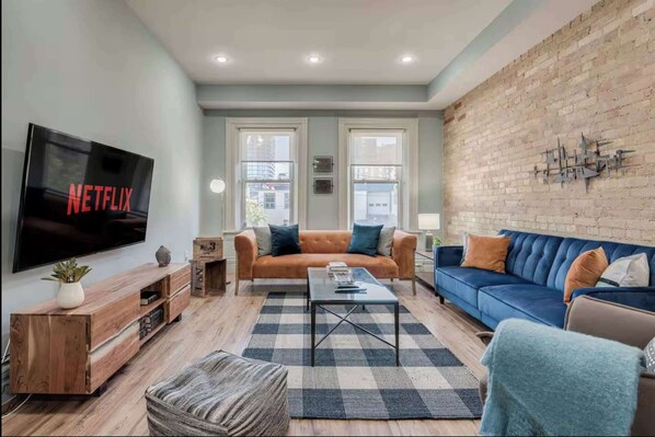 Modern Furnished Living Room with Brick Wall