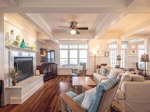 Open-concept living area with stylish decor, abundant natural light, and seamless flow to the dining and kitchen areas.