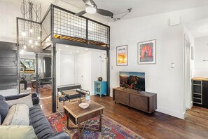 Spacious studio apartment with queen bed, cozy couch, tv, storage for gear and galley kitchen.