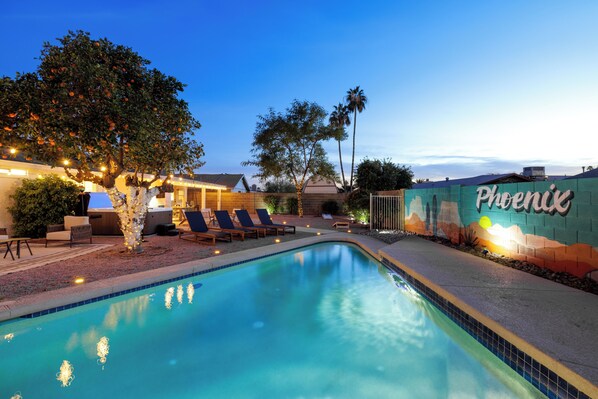 Enjoy the backyard oasis, heated pool, hot tub, fire pit & tons of games