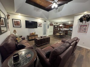 Second floor living room with reeling couches and 55" tv with fire stick. 