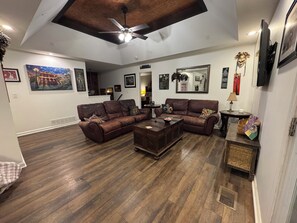 Second floor living room with reclining couches.