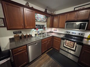 Fully stocked kitchen with views of lake out kitchen window.