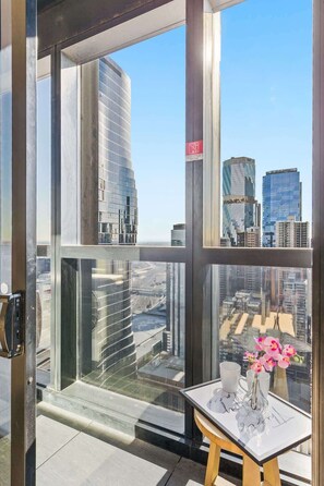 A private balcony with city views. *(Stool on balcony is from the room).