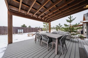 Enjoy the fresh air on the covered deck with outdoor seating 