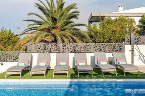 Heated infinity pool with sun loungers and sea view in Luxury Villa Destiny Ciovo at the beach
