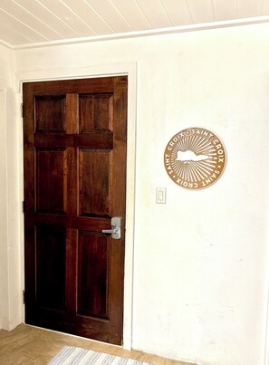 Entry door at the end of the hallway.