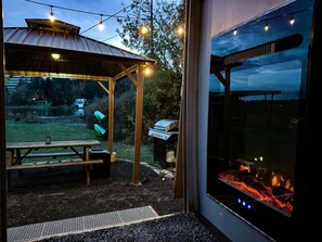 Electric fireplace with a water view at dusk. 