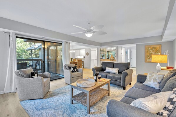 Spacious living area with serene golf views and covered patio dining for 6