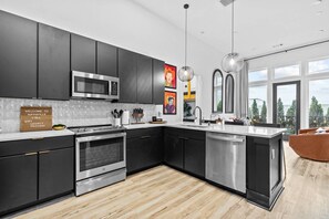 Gourmet kitchen with pendant lighting and premium surfaces