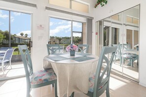 Enjoy meals in this sunlit dining area overlooking the beautiful community garden. A cozy space for family dinners or romantic evenings.