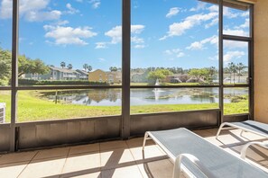 Unwind on the screened patio with stunning lakefront views. A peaceful spot for morning coffee or evening relaxation. Equipped with loungers for ultimate comfort.
