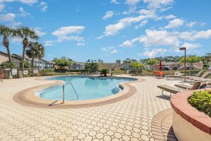 Dive into the sparkling waters of the resort-style pool, surrounded by lush greenery and plenty of loungers for soaking up the sun. Perfect for family fun or quiet relaxation.