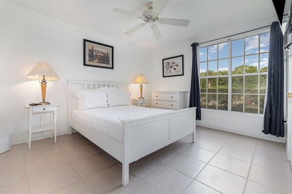 Relax in this bright and spacious bedroom featuring a comfortable bed, elegant decor, and serene garden views. Ideal for restful mornings and peaceful evenings.