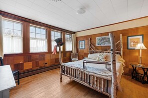 This bright and spacious bedroom features a whimsical birch bed frame, delightful Alice in Wonderland décor, and large windows that flood the room with natural light. Enjoy serene views of the Saco River right from your bed.