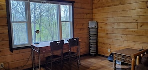 A desk in the living room overlooks the adjacent wetland, part of the pasture.
