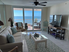 Bright open living room looking out onto gulf