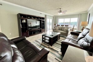 The living room includes a large, flat screen, Smart TV.