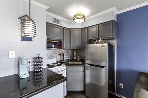 Well-equipped kitchen with granite countertops and cozy decor.