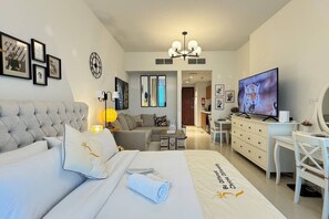 Relax in this inviting space, with a cozy bed and a chic sofa for ultimate comfort.