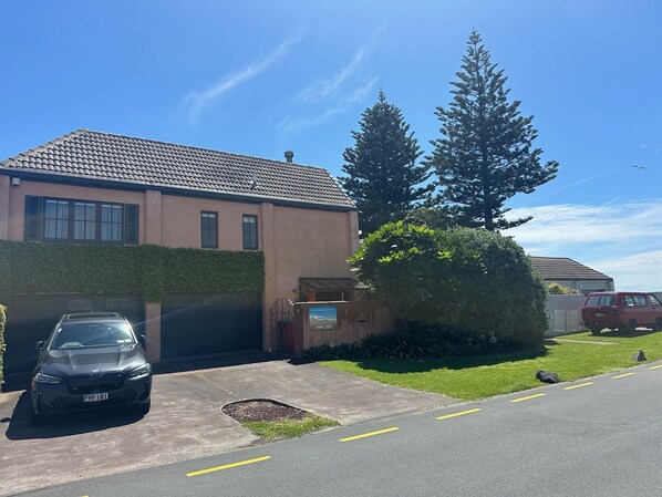 house with car parking space in front of garage