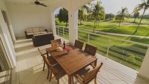 The private terrace offers a dining table and cushioned seating