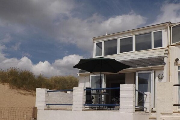 A large patio with furniture to enjoy the phenomenal beach view!