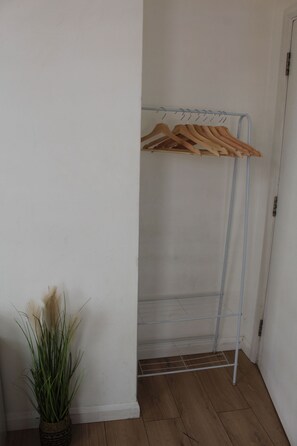 Clothes rail to hang your clothes. We also have an iron and ironing board