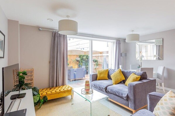 Ground floor of this deluxe city centre apartment comprises of an entrance hallway, downstairs WC, utility cupboard and large open plan living room with patio doors opening into a private courtyard garden.