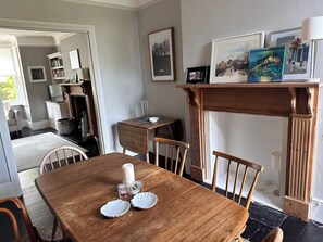 Dining room with two ercol tables, matching chairs.
