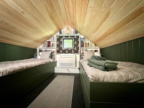 Lofted space, 2 twin sized beds (accessed by ladder); Due to ladder access, sleeping here is at your own risk. We do not recommend use by children under age 7