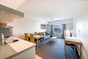 The open plan living, dining and kitchen area is flooded with natural light. It features a dedicated workspace, ideal for travelling on business.  
