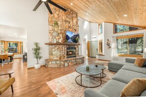 Vaulted pine ceilings and open floor plan provide a spacious feel