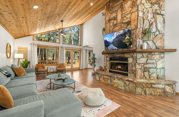 Large floor-to-ceiling fireplace and 360 degree forest views