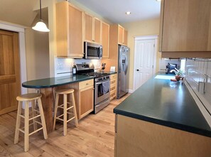 Custom cabinetry, durable corian countertops, SS appliances and eat-in nook