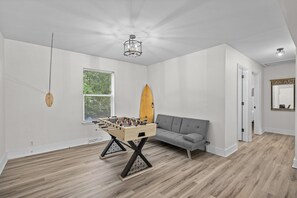Game room with foosball, tiki toss, board and card games. 