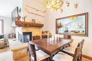 The cozy main living area of this Deer Valley condo is cozy with a large rustic gas fireplace, dining area for 6 and a large living room seating area.  It's the perfect spot for a large family or group to relax after a day of adventures.