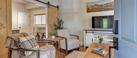 Living Room has lots of natural light, a TV with Roku Guest Mode and board games