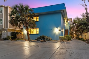 Front of Unit with parking area ay twilight